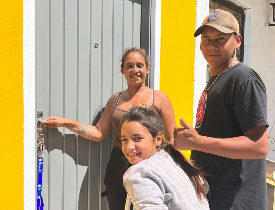 Familia participante de Rivera en la puerta de su nueva vivienda