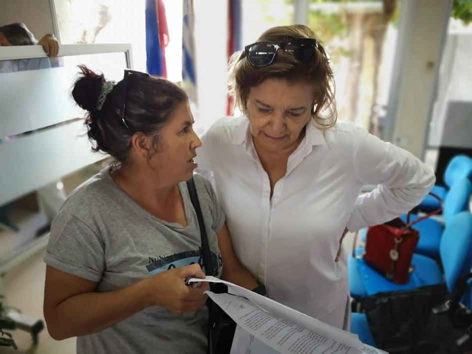 Encuentro en durazno Eneida de León y una mujer mirando un documento
