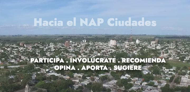 Fotografía de ciudad con texto sobreimpreso que dice Hacia el Nap Ciudadades