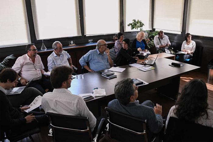 Sala de reuniones con representantes de ASSE y Dinot, autoridades y equipos técnicos de ambas instituciones sentados alrededor de una mesa dialogando