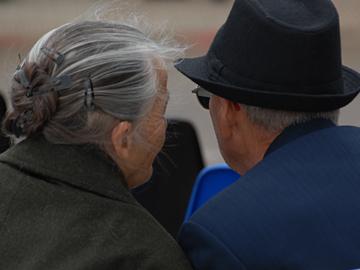 Adultos mayores en banco de plaza