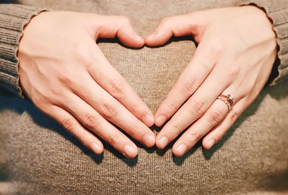 Vientre de mujer embarazada con sus manos sobre él