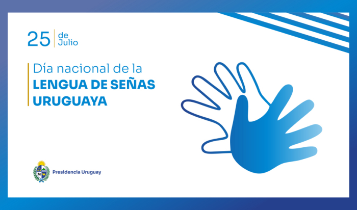Placa en blanco con letras celestes que dice “Día Nacional de la Lengua de Señas Uruguaya”.