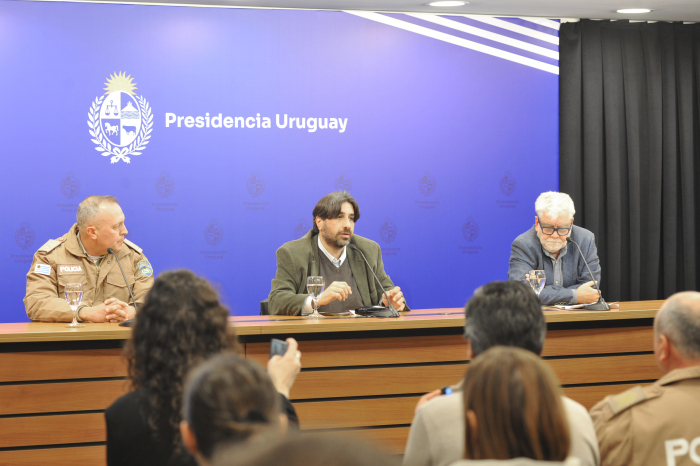 Metediera; Rossi y Calzada sentados en mesa con micrófonos en sala de prensa de Torre Ejecutiva