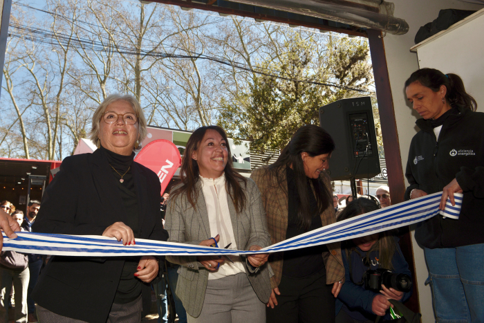 Ministra de Industria, con una tijera en mano, corta la cinta de inauguración del stand 