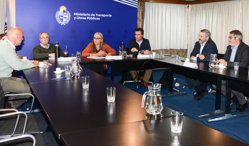 Ministra Lucía Etcheverry junto a Mario Bergara y Francisco Legnani y demás participantes de la reunión alrededor de una