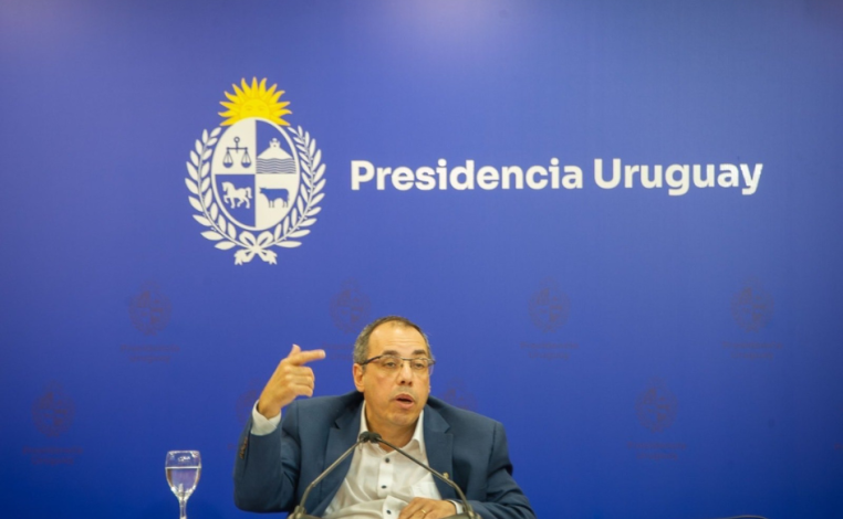 Ministro de Turismo, Pablo Menoni, habla en sala de prensa de Torre Ejecutiva. Detrás, el logo de Presidencia Uruguay