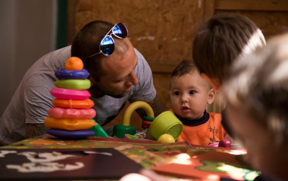 Justin, un niño de un año, junto a su padre en el jardín donde lo cuidan 