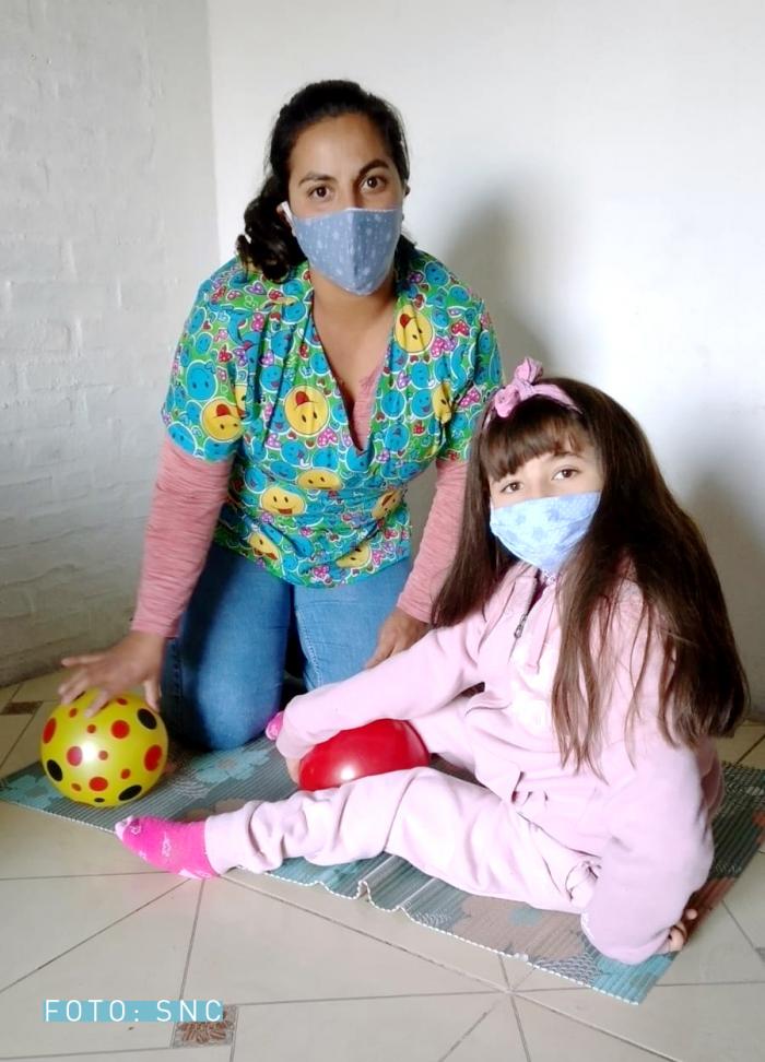 Romina, asistente personal, con Dana, la niña de 9 años a la que asiste