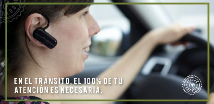 Mujer conduciendo a la vez que habla con teléfono manos libres