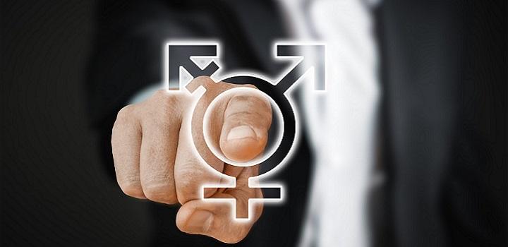 Persona coloca su dedo sobre los signos de género unidos entre sí Imagen ilustrativa
